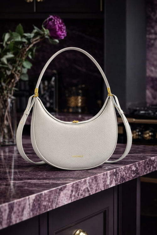 Light grey minimalist crescent bag with elegant structured shape