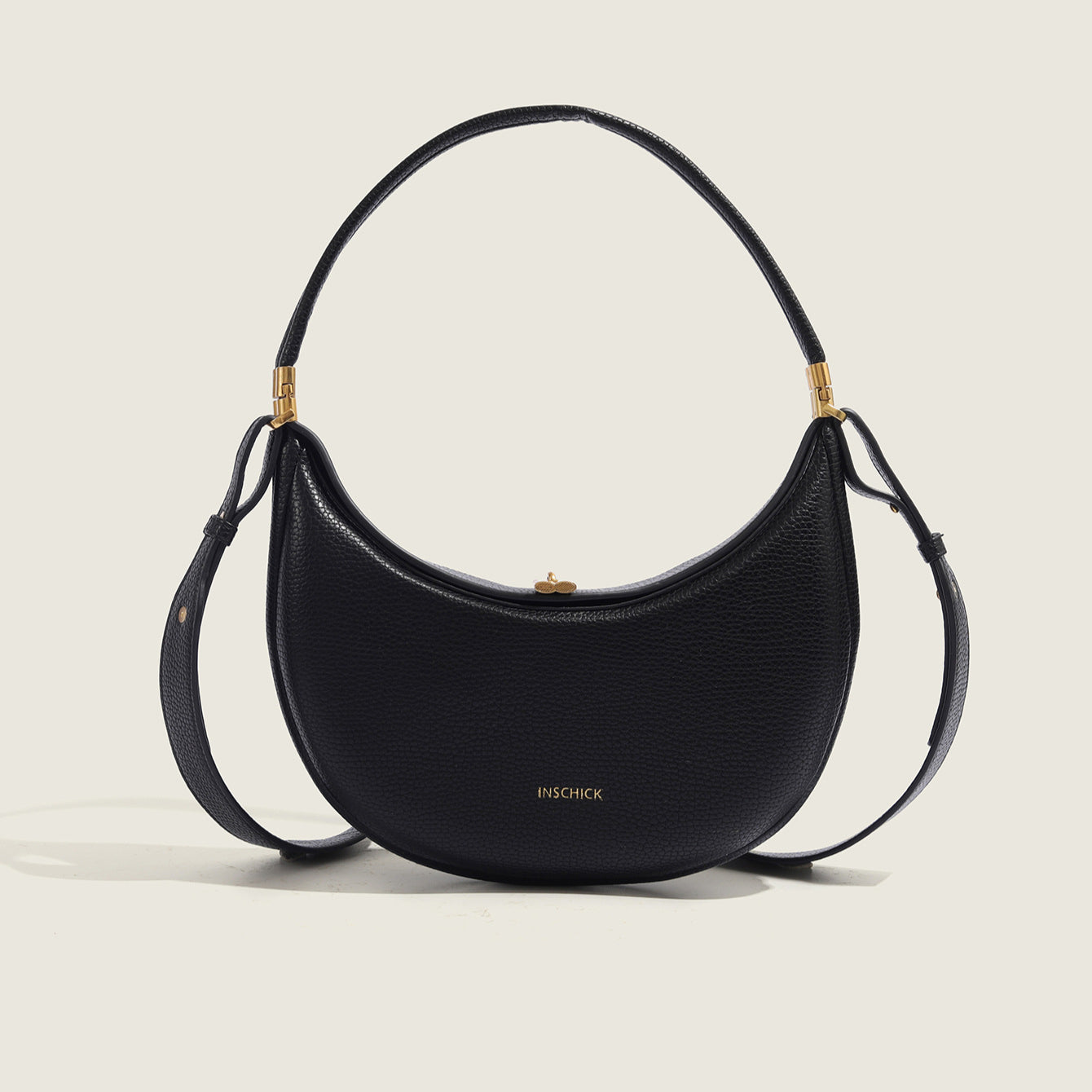 Minimalist black crescent shoulder bag with sleek modern silhouette